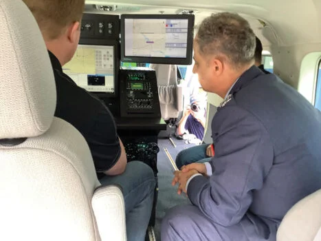 IOMAX Systems Engineer Greg Jones demonstrates onboard ISR border patrol technology to Royal Jordanian Air Force Commander Brigadier General Hiyasat